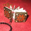 Measuring 3/4' square, this charming mini-book has covers upcycled from a bracelet, & is coptic bound with a clasp for attaching to a necklace or bag.
<p><a href='http://craftgawker.com/post/2010/03/05/13092/' target='_blank'>This piece was featured on CraftGawker.com</a></p>